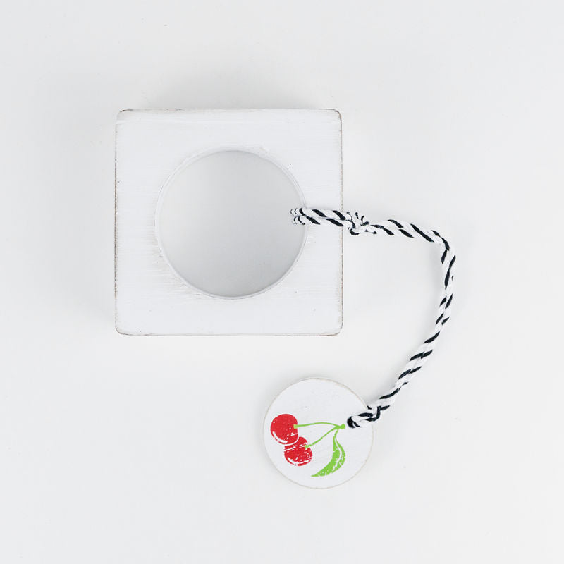 Colorful cherry wood napkin ring styled with a cloth napkin.