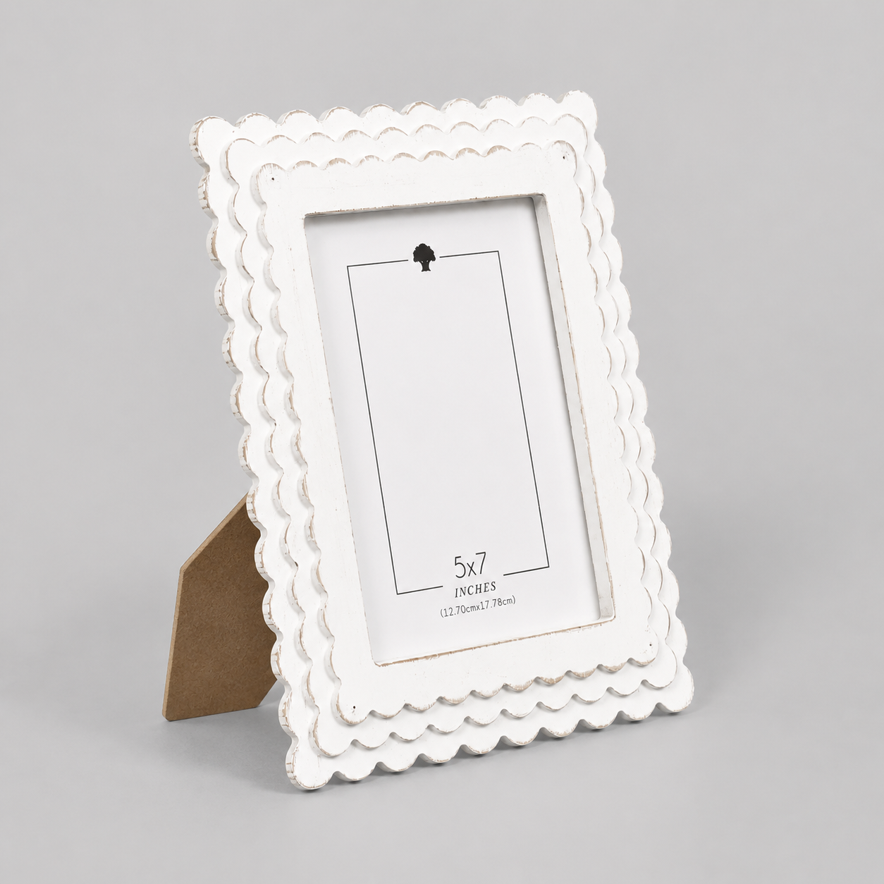 White scalloped wood picture frame holding a 5x7 photo