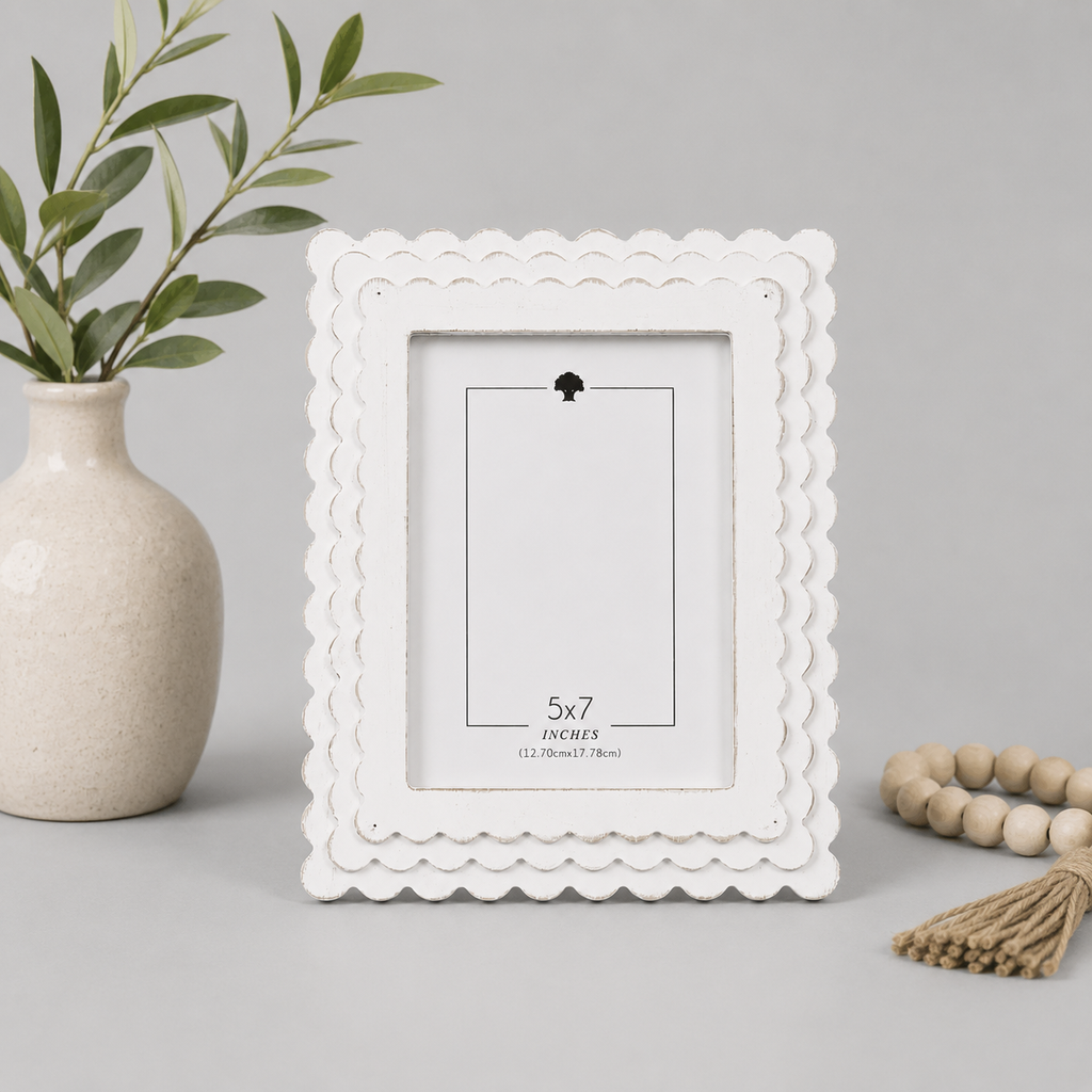 White scalloped wood picture frame holding a 5x7 photo, side detail view