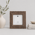 Espresso scalloped wood picture frame holding a 4x4 photo, side detail view