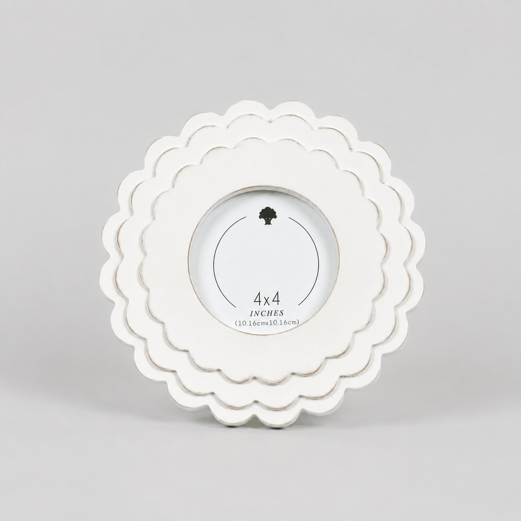 White round scalloped wood picture frame holding a 4x4 photo