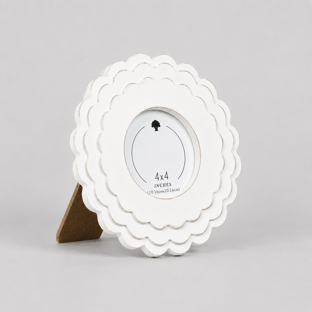 White round scalloped wood picture frame holding a 4x4 photo