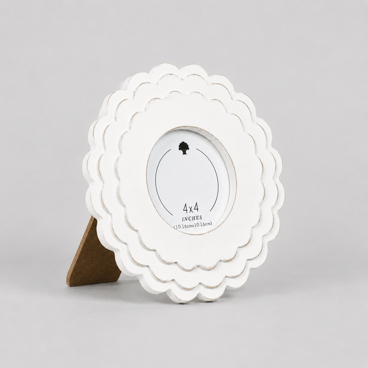 White round scalloped wood picture frame holding a 4x4 photo