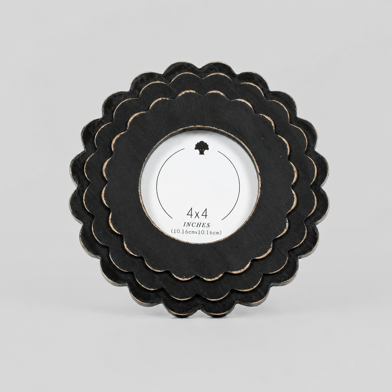 Black round scalloped wood picture frame holding a 4x4 photo