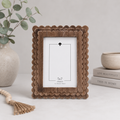 Espresso scalloped wood picture frame holding a 5x7 photo, side detail view