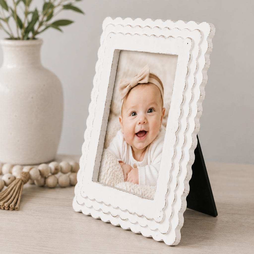 White scalloped wood picture frame holding a 5x7 photo, angled view