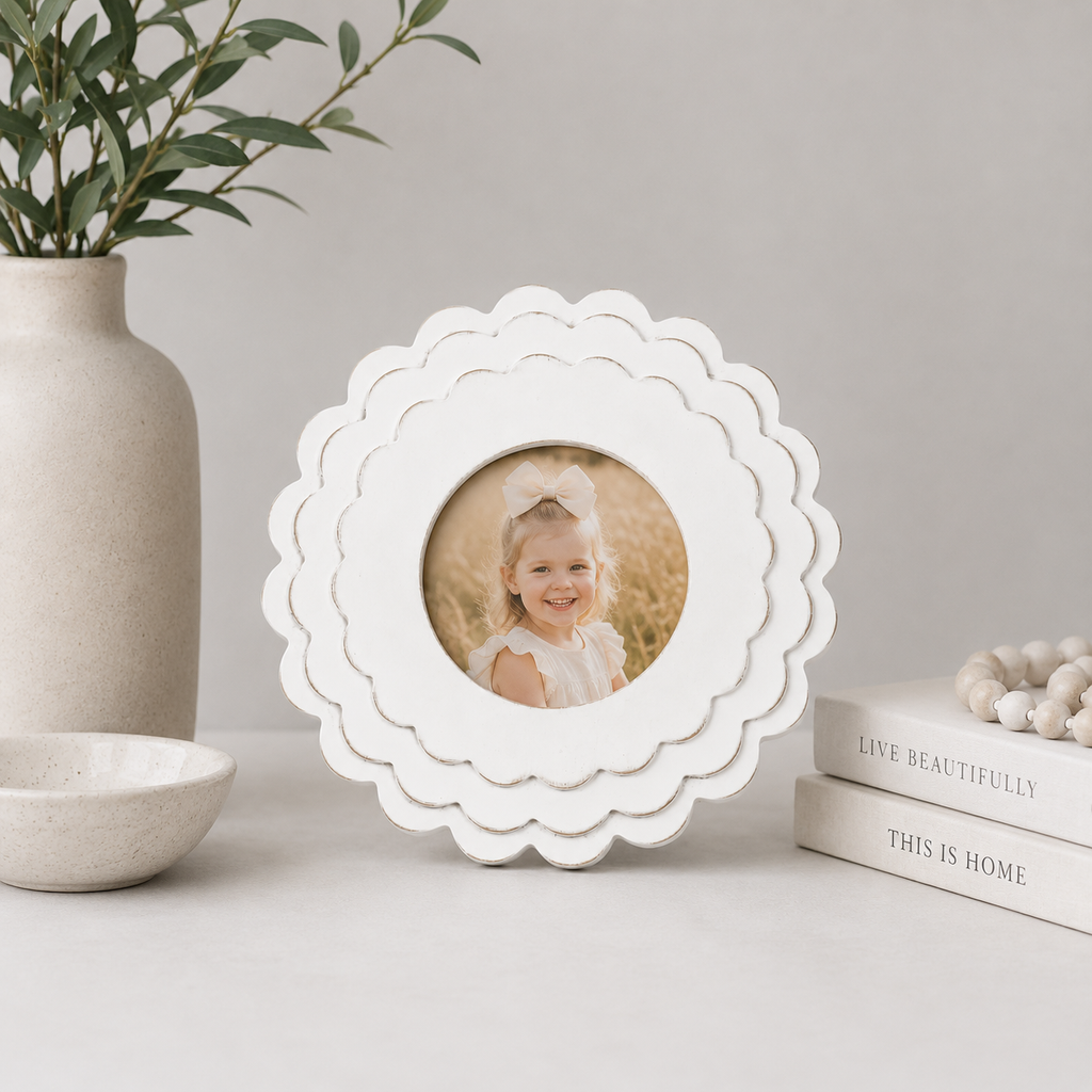 White round scalloped wood picture frame holding a 4x4 photo, side detail view