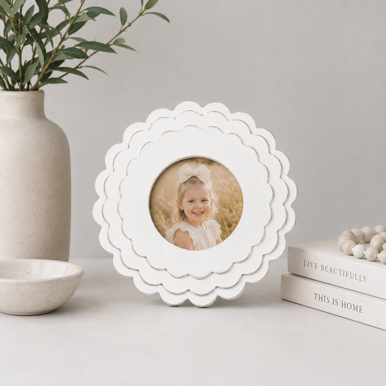 White round scalloped wood picture frame holding a 4x4 photo, side detail view