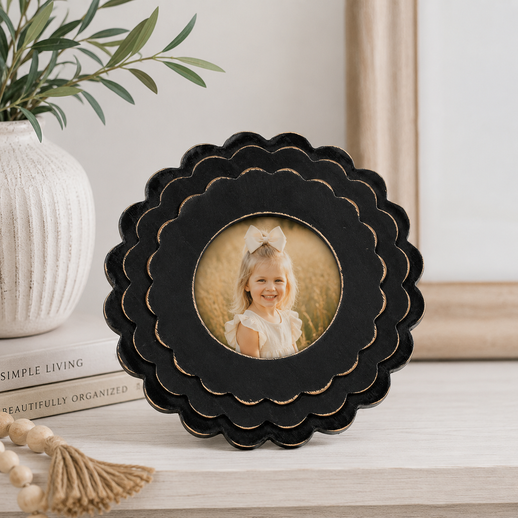 Black round scalloped wood picture frame holding a 4x4 photo, front view