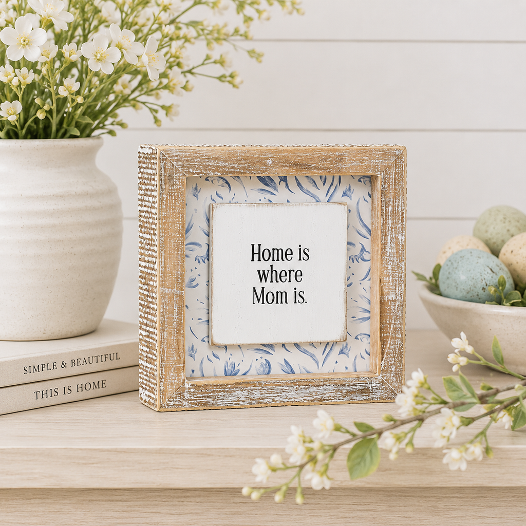 Reversible wood framed sign featuring home and mom styled on a shelf or console table.
