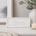 Wood framed sign featuring forever in our hearts styled on a shelf or console table.