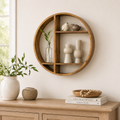 24-inch round natural wood wall shelf styled with decorative accents.
