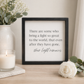 Wood framed sign featuring their light remains styled on a shelf or console table.
