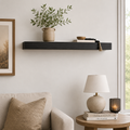 35-inch black wood floating shelf mounted on a wall for home decor display